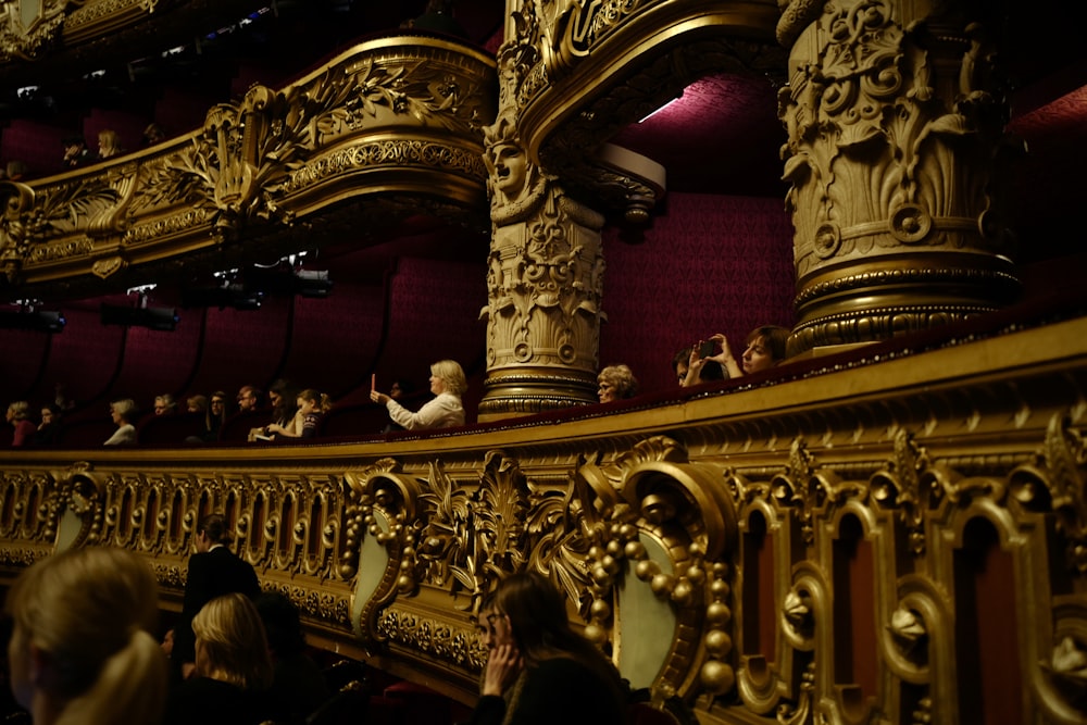 people sitting on gold chair