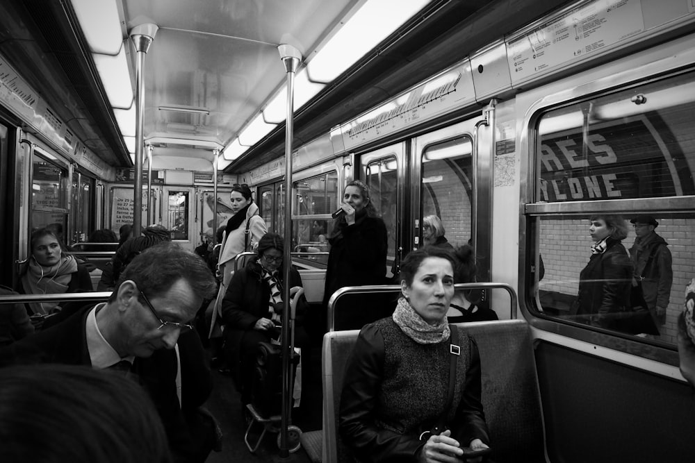 grayscale photo of people in train