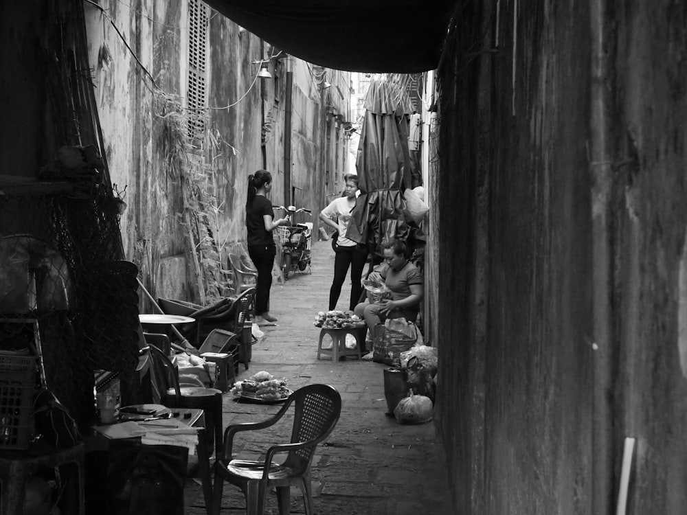 grayscale photo of people sitting on chairs