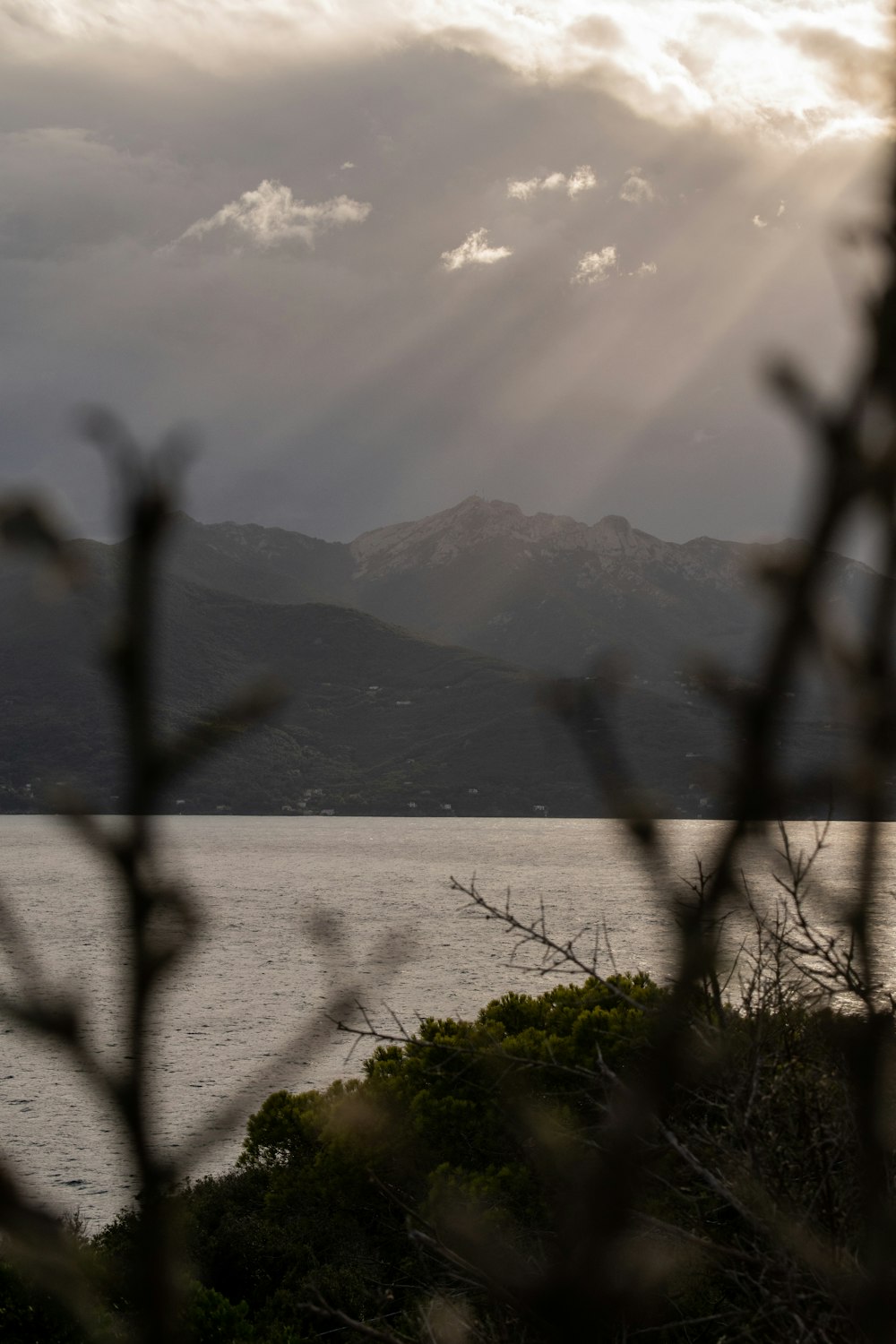 body of water near mountain during daytime