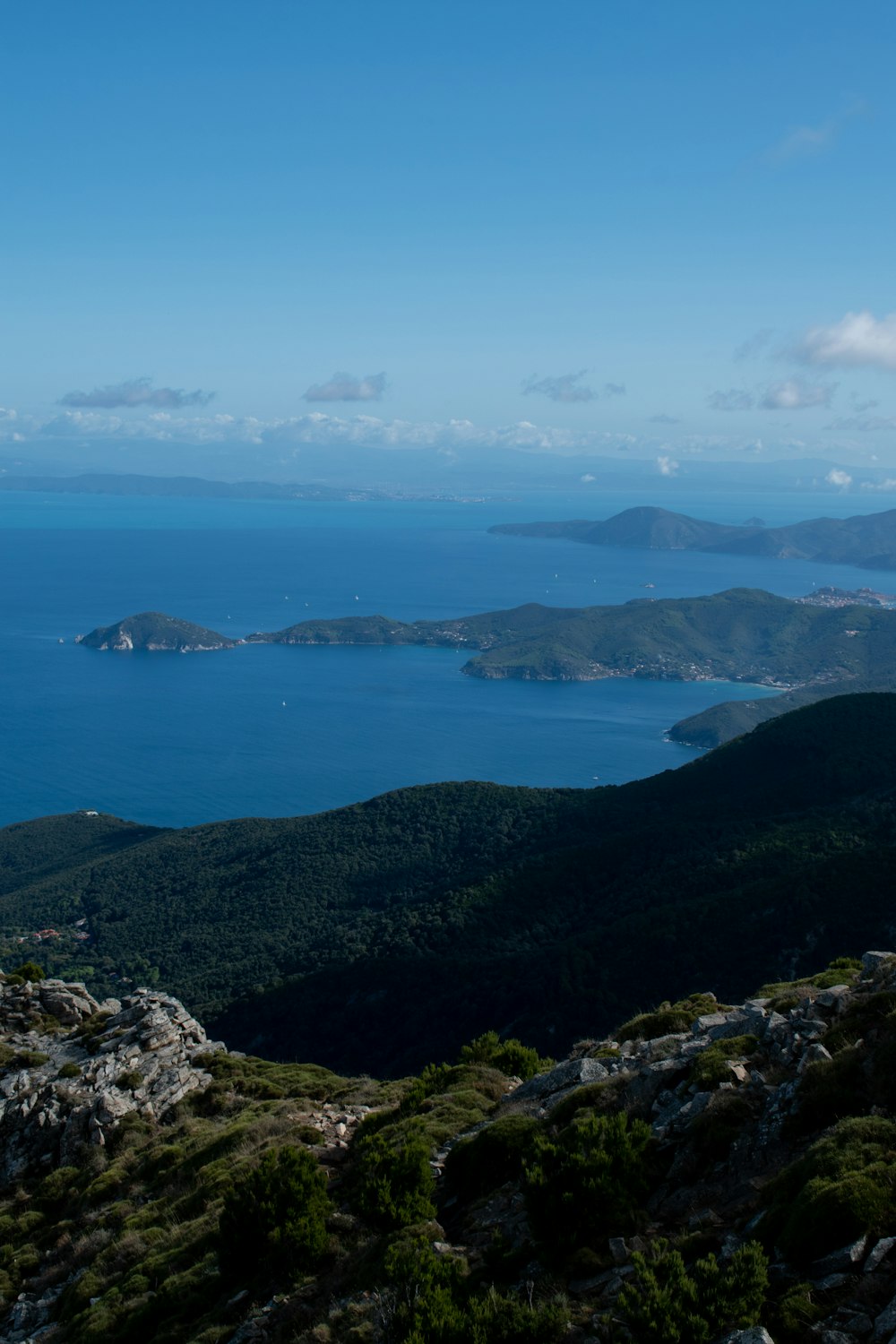 green mountains near body of water during daytime