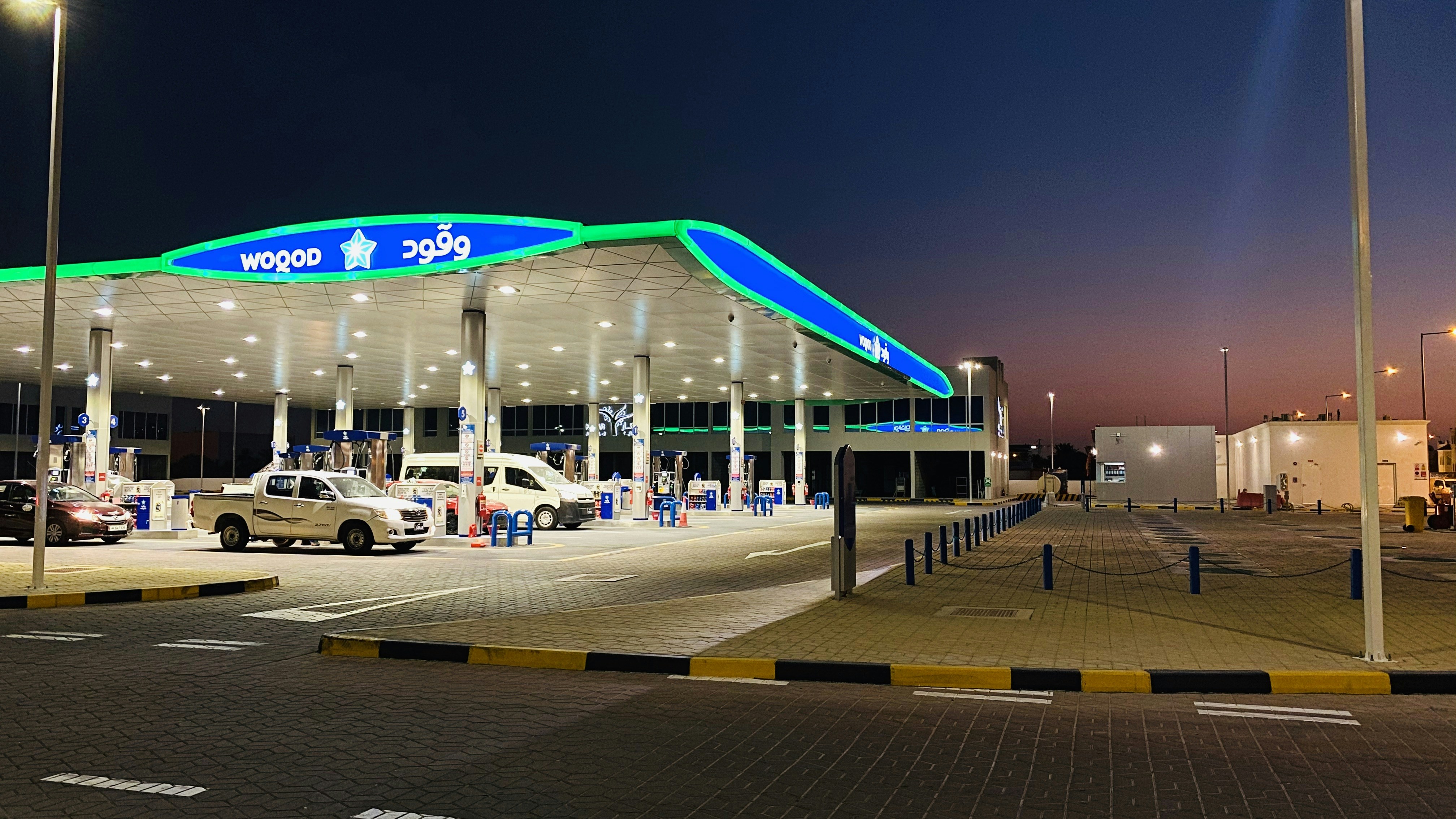 white and blue car on road during night time