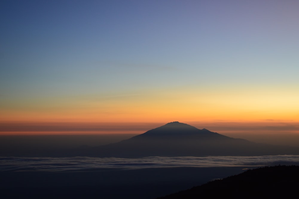 silhouette of mountains during sunset