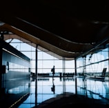 A business traveler confidently walking through a modern airport with Carleone Neres branding.