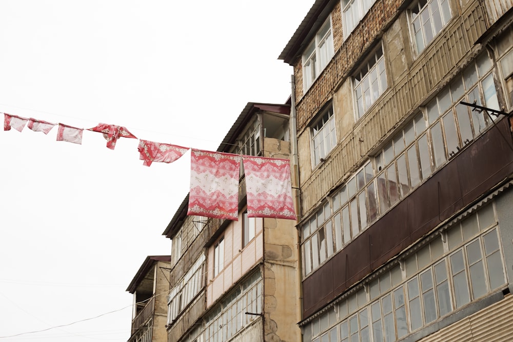 brown concrete building with red flag on top