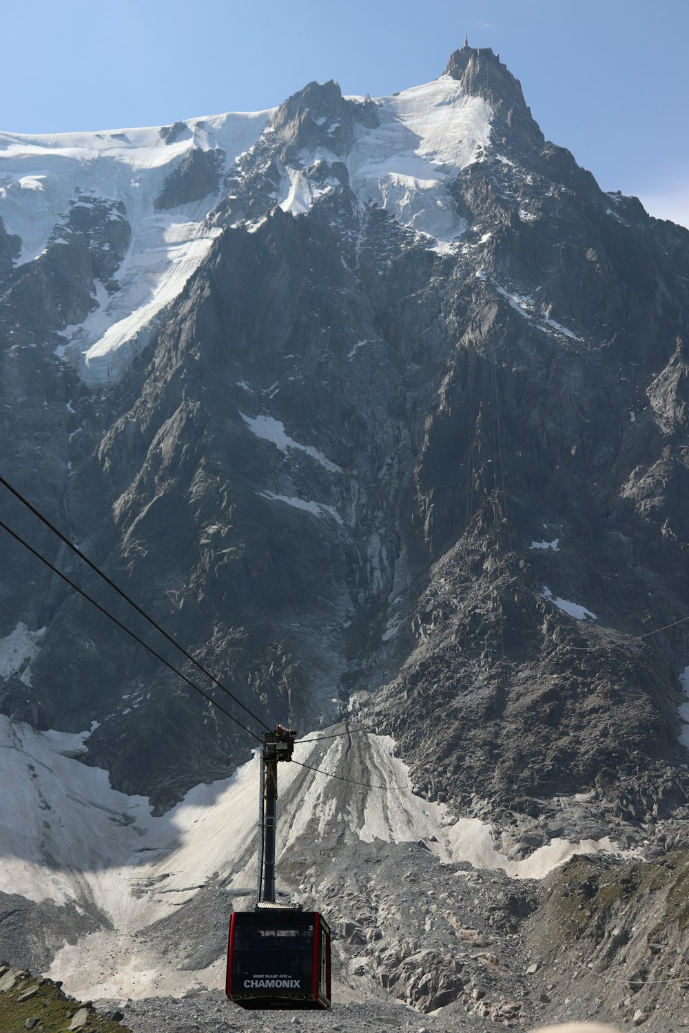 a ski lift going up a snowy mountain