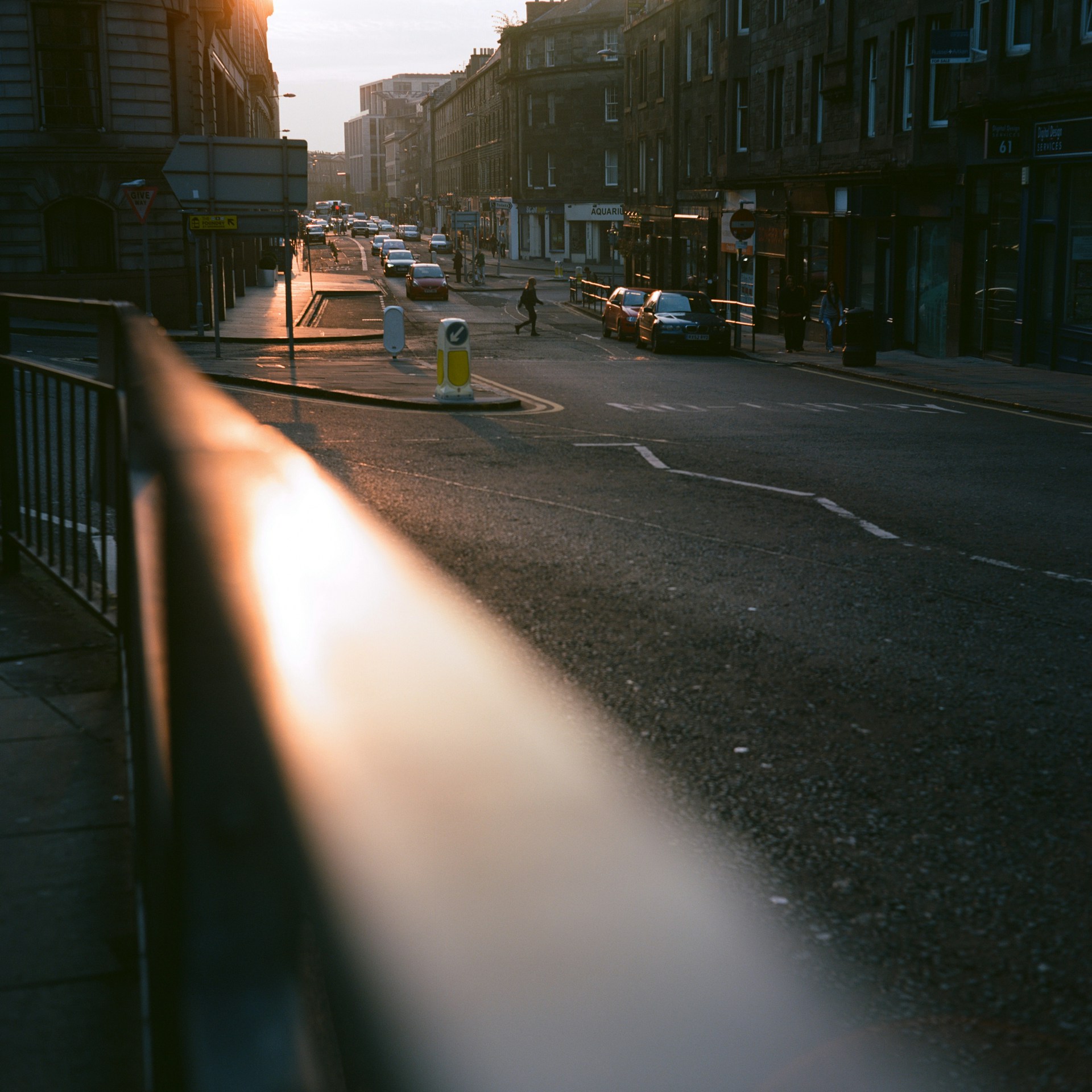 A vibrant street scene bathed in golden hour light, highlighting everyday moments with warmth.