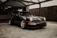 black porsche 911 parked in garage