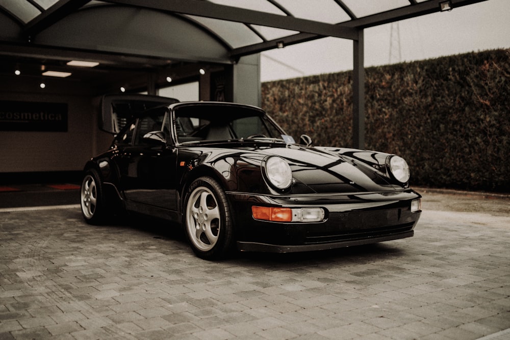 black porsche 911 parked in garage