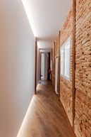 brown and white hallway with white wall