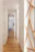 A bright hallway in a rental property showing fresh paint and clean, protected floors.