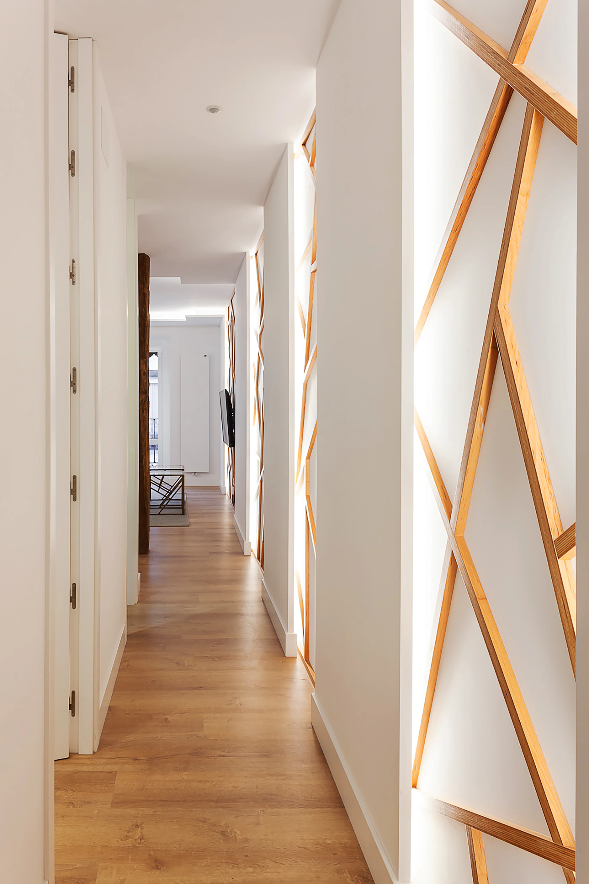 A bright hallway featuring newly installed high-quality laminate flooring that complements the home's style perfectly.
