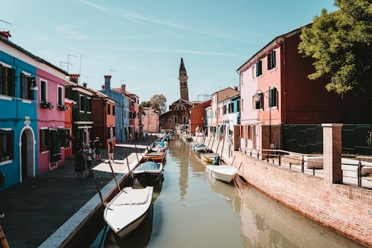 white and blue boat on river near brown concrete building during daytime in Ristorante Da Forner Italy