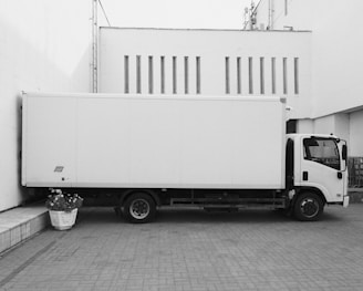 white truck parked near white building