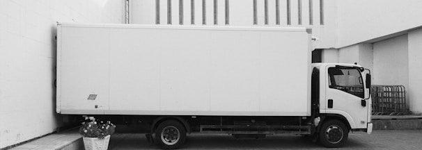 white truck parked near white building