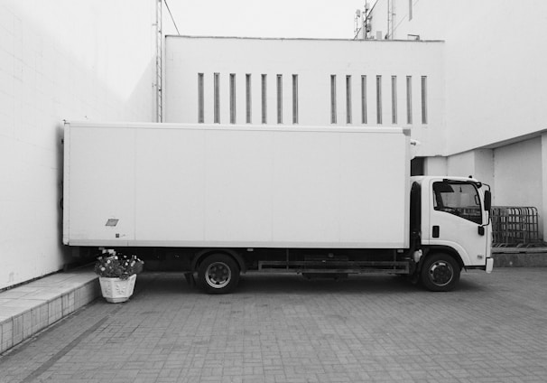 white truck parked near white building