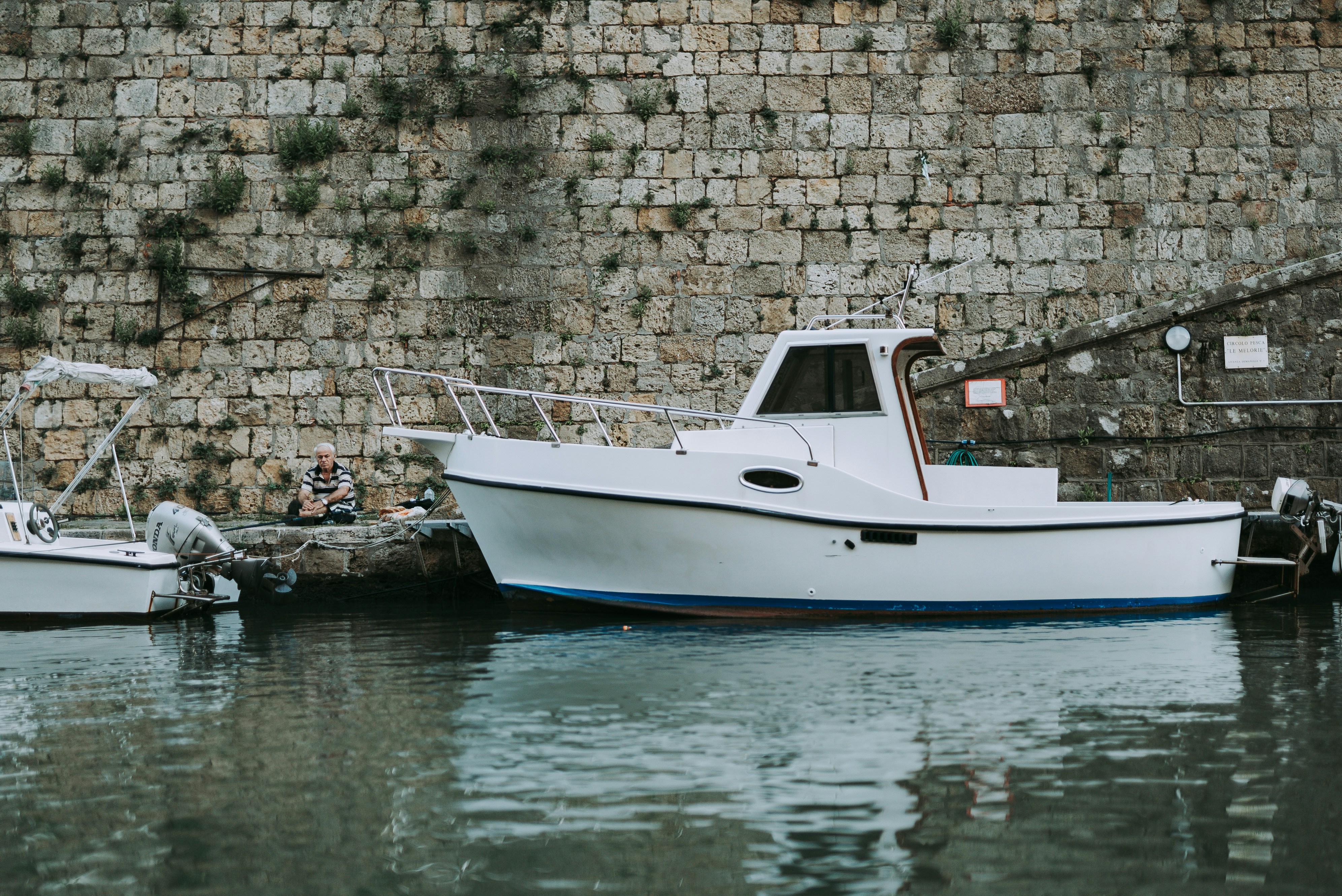 white and blue boat on water during daytime