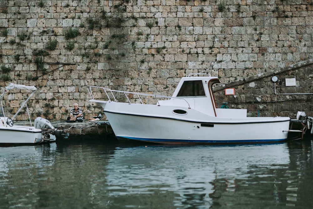 white and blue boat on water during daytime