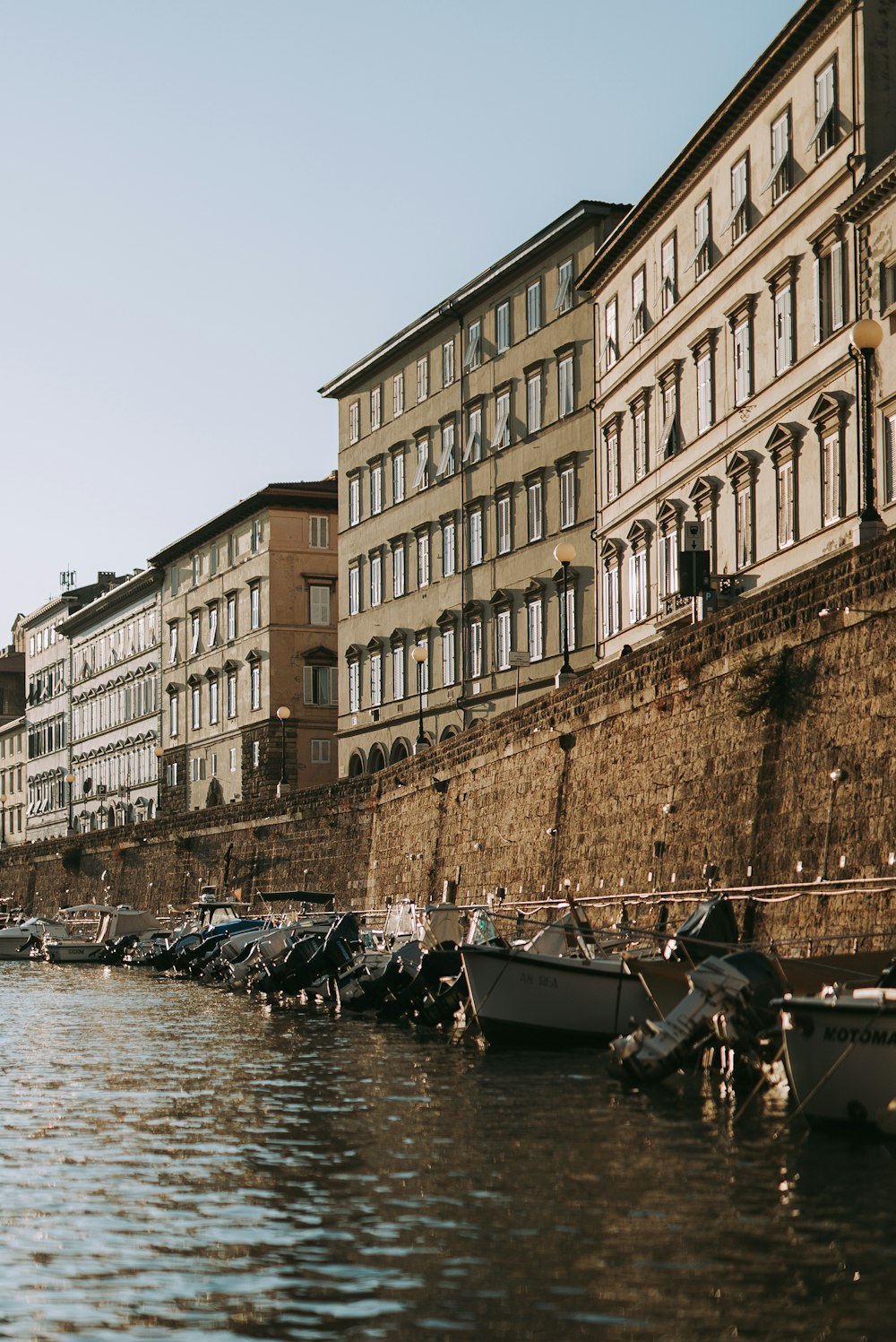 people riding on boat on river near brown concrete building during daytime