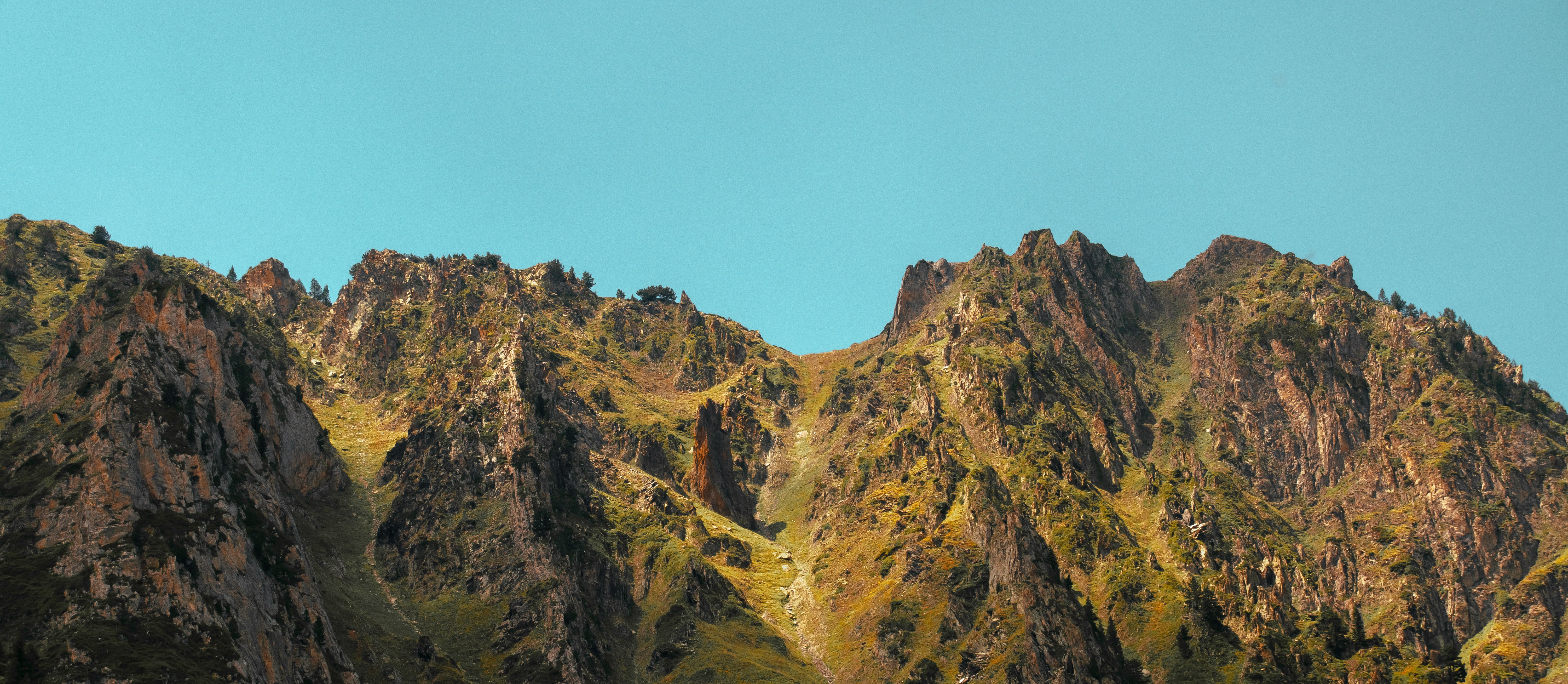 brown rocky mountain under blue sky during daytime