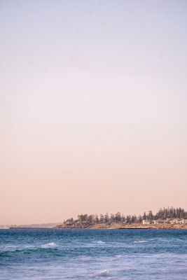 white and brown house near body of water during daytime