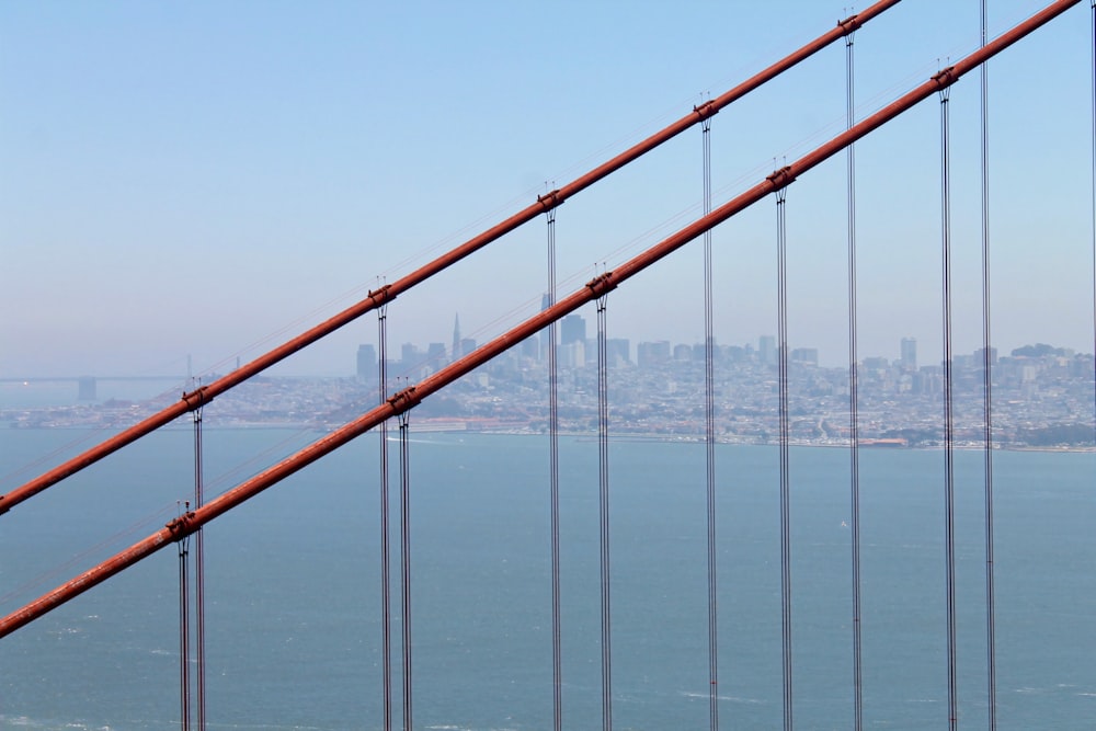 brown metal bridge on body of water during daytime