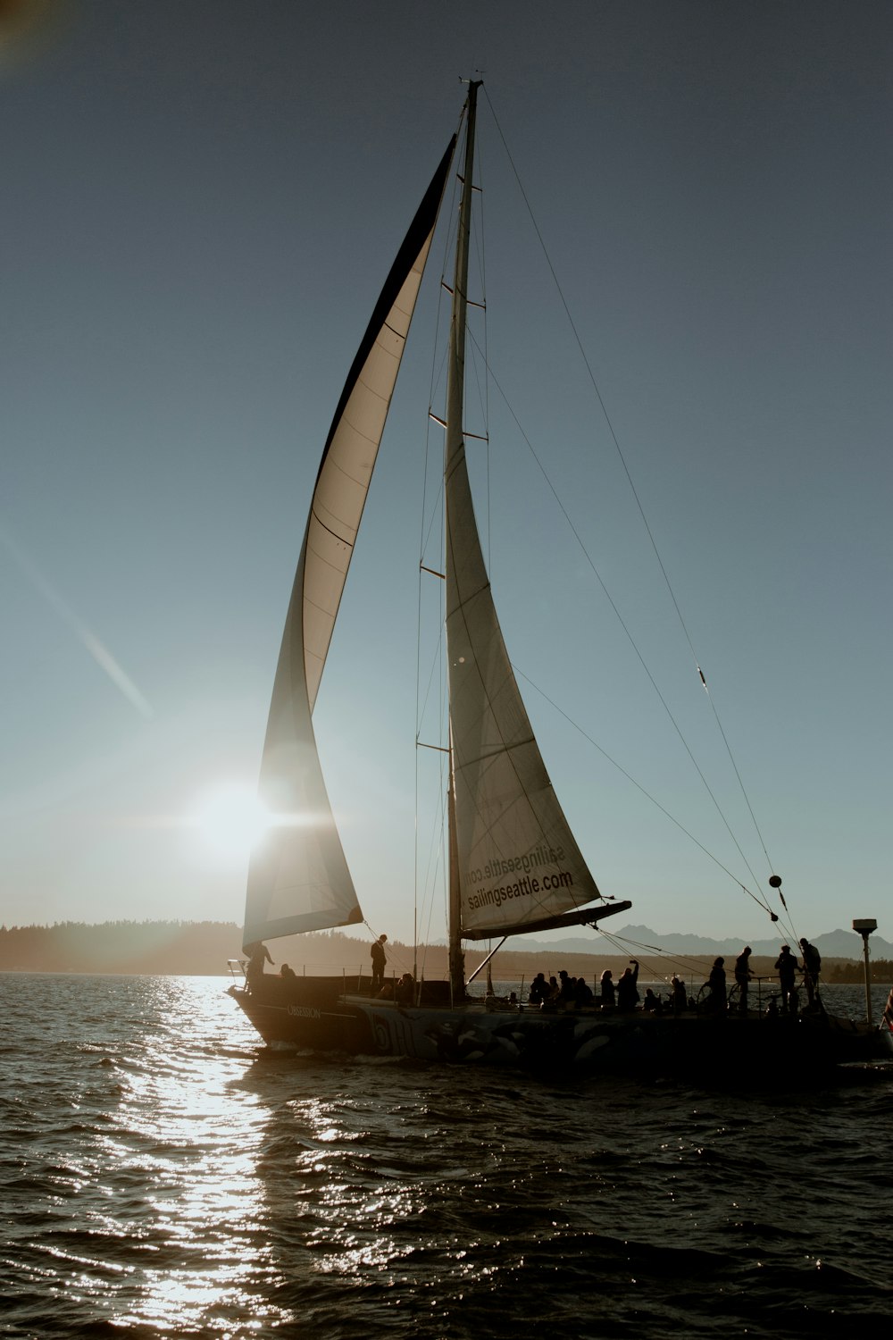 white sail boat on sea during daytime