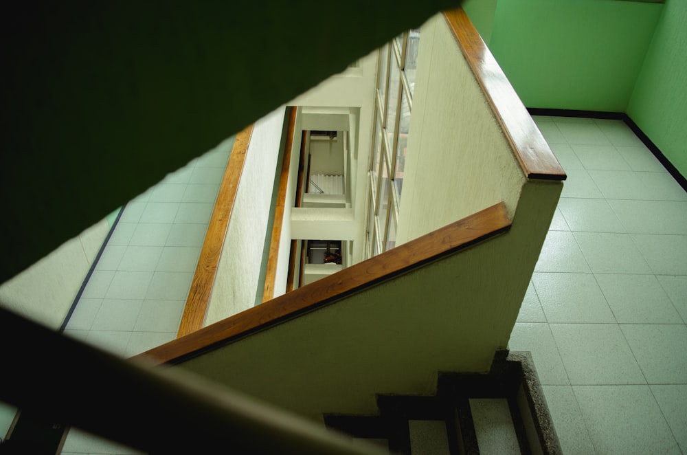 black wooden staircase on white ceramic tiles