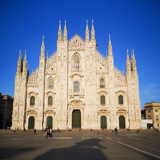 people walking near beige concrete building during daytime in Milan Cathedral Italy