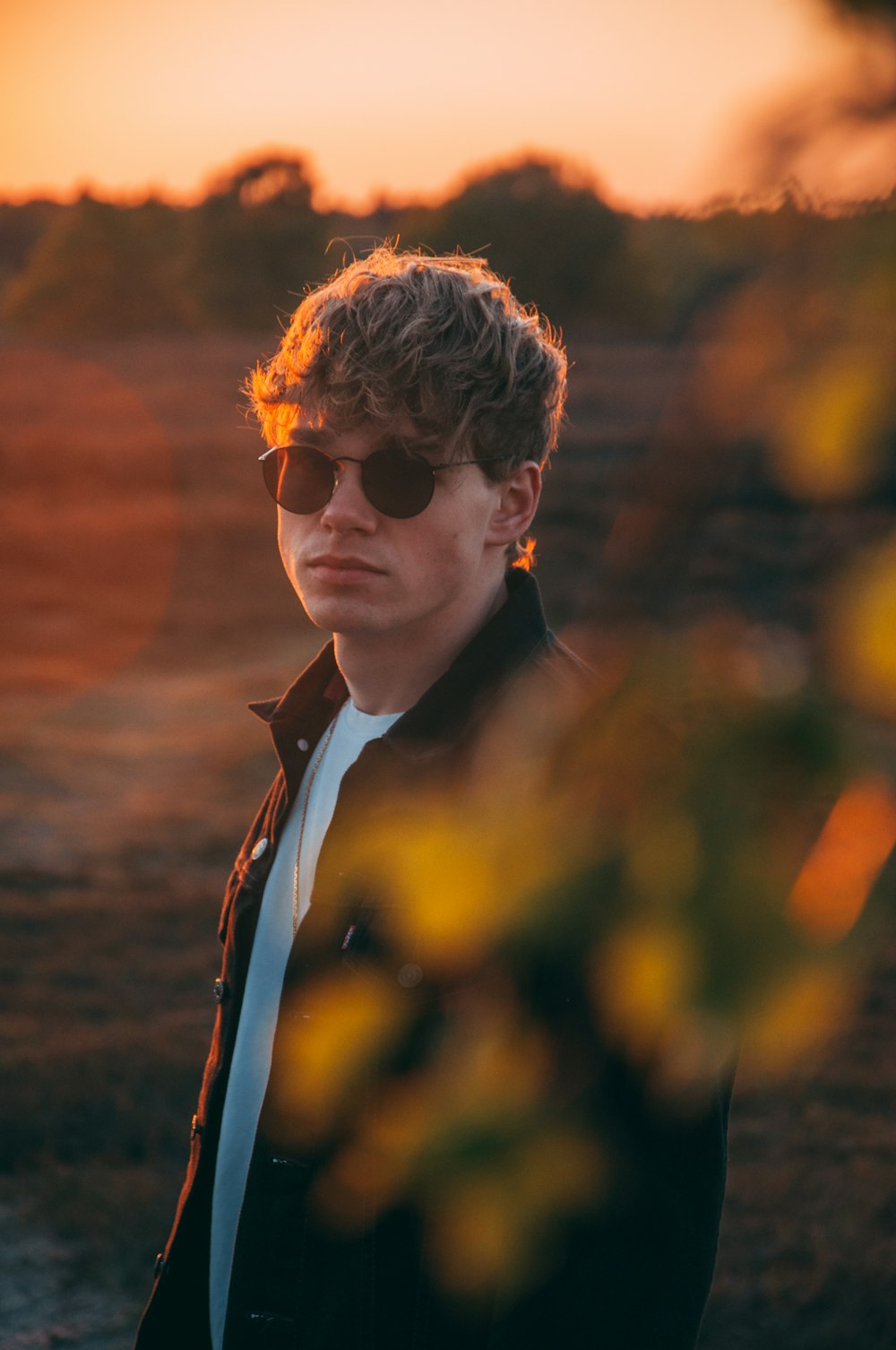 man in black suit jacket wearing sunglasses