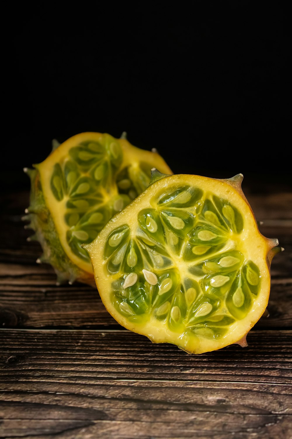 a couple of pieces of fruit sitting on top of a wooden table