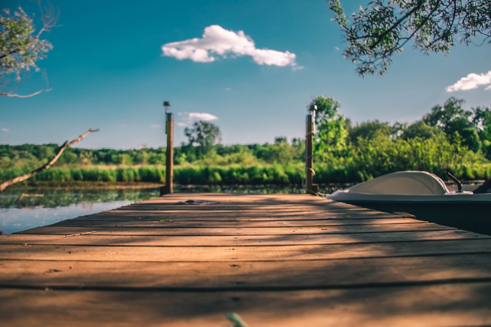 brown wooden table near green trees under blue sky during daytime