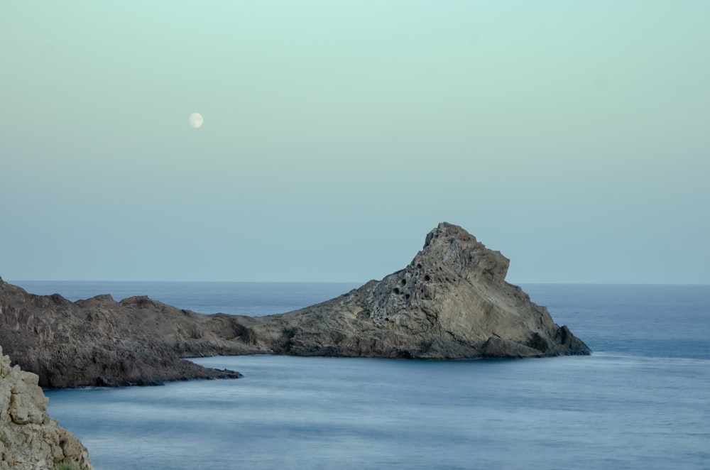 brown rock formation on blue sea water during daytime