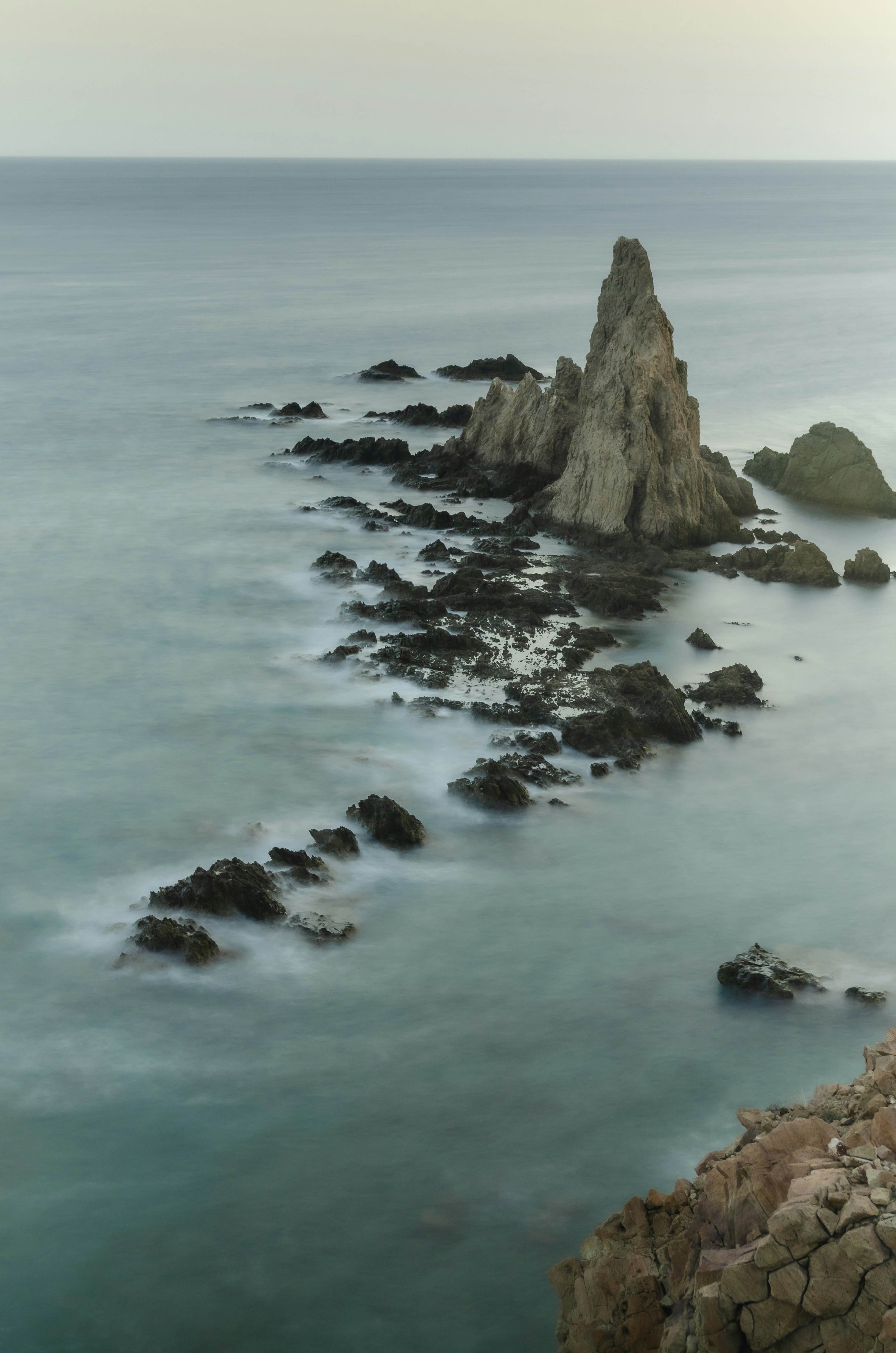 brown rock formation on sea during daytime