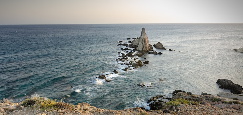 brown rock formation on sea during daytime