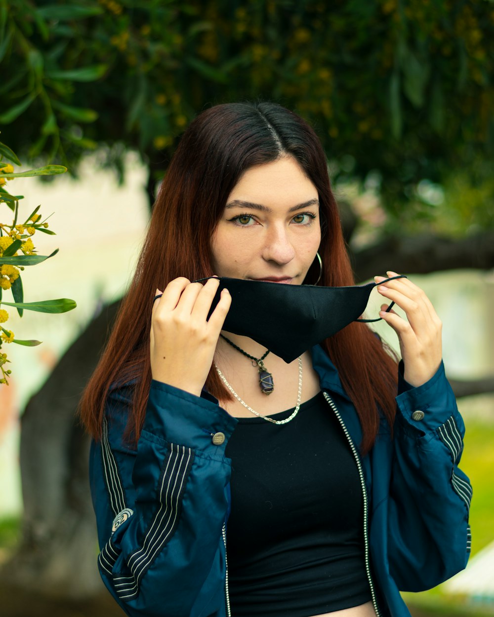 woman in blue button up shirt covering her face with her hair