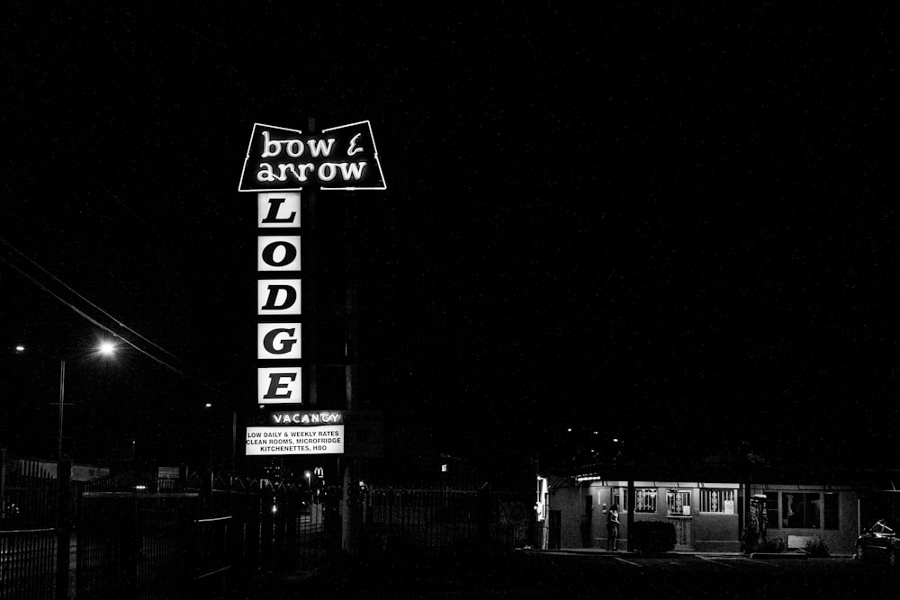a black and white photo of a motel sign
