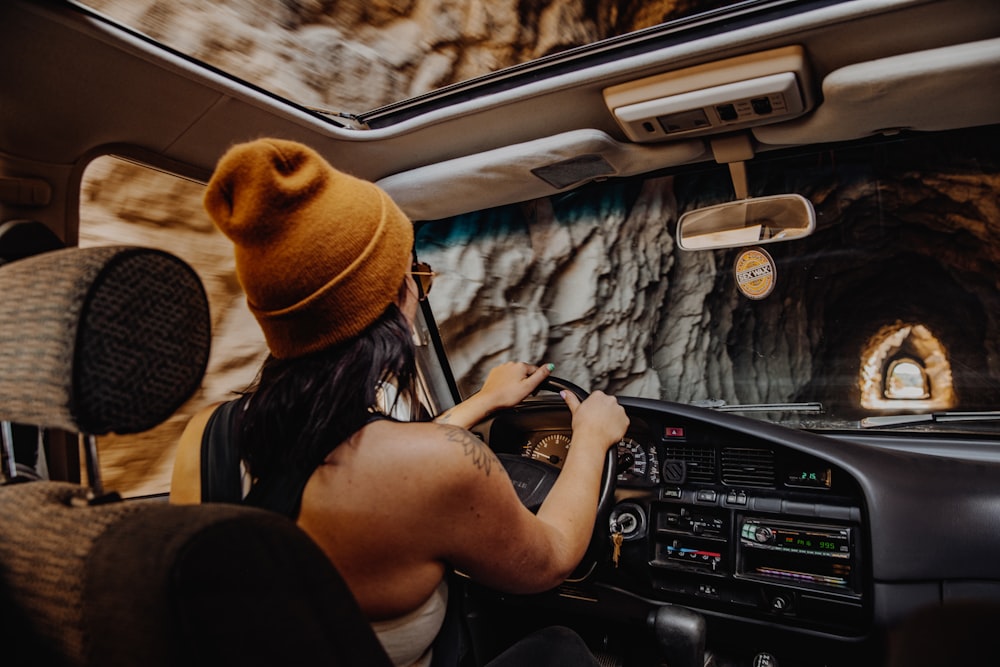 woman in black and white stripe shirt driving car