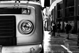 a black and white photo of a truck parked on the side of the road