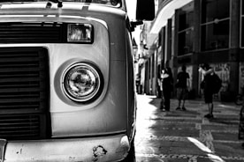 a black and white photo of a truck parked on the side of the road