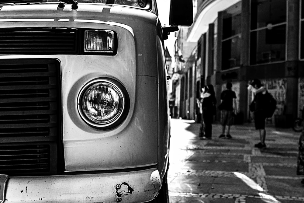 a black and white photo of a truck parked on the side of the road