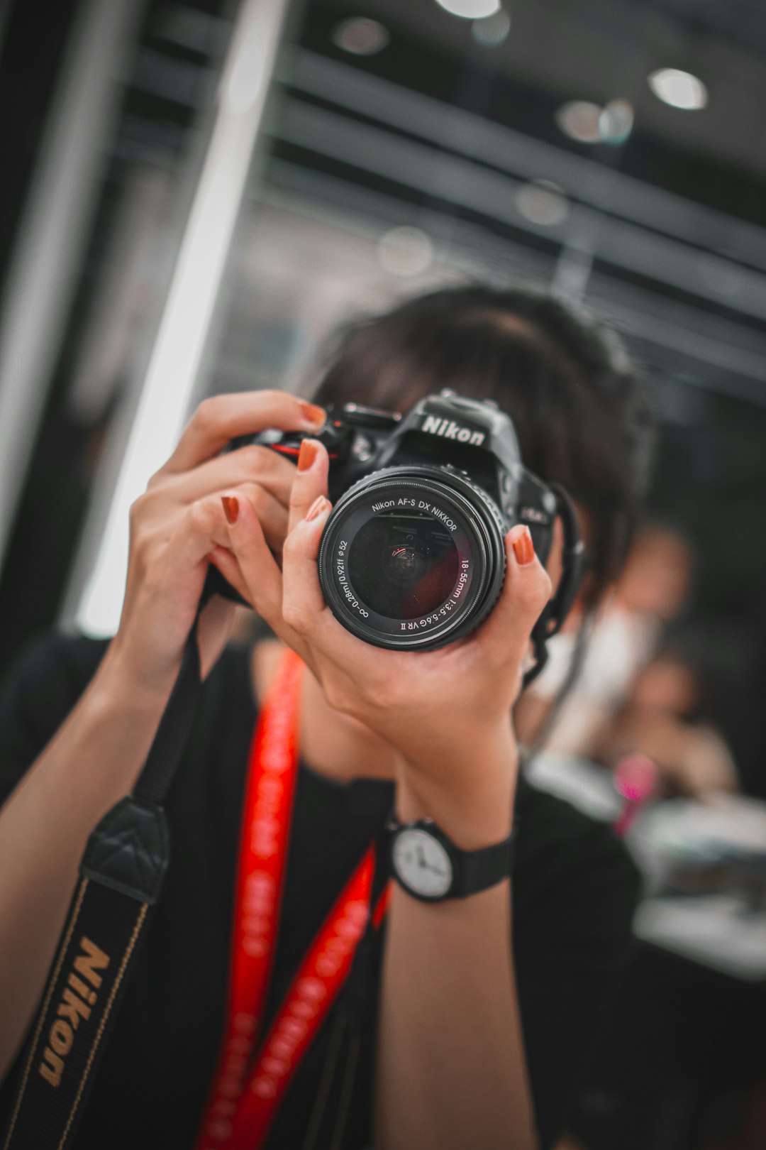 person holding black nikon dslr camera