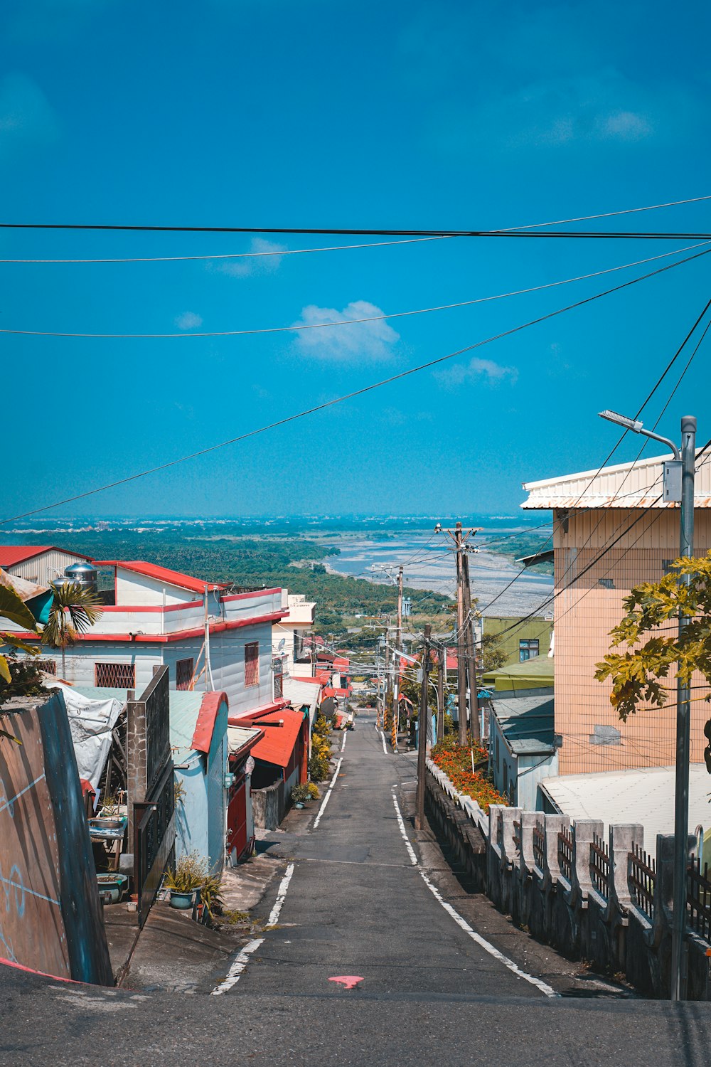 houses near body of water under blue sky during daytime