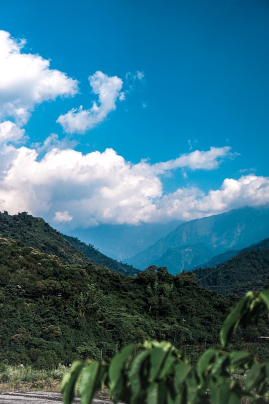 green mountain under blue sky and white clouds during daytime in Pingtung Taiwan