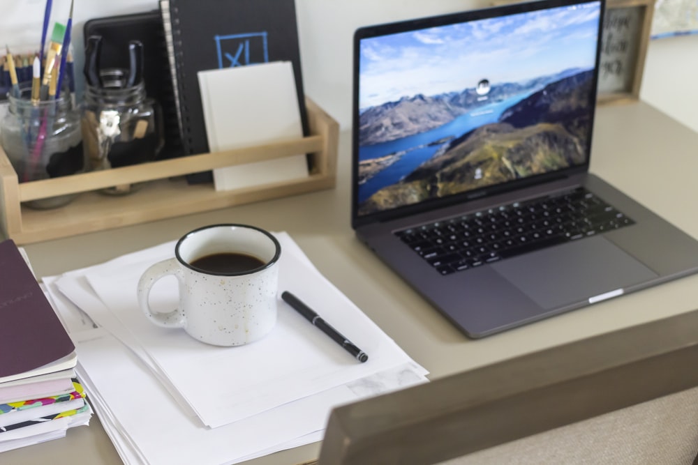 white ceramic mug on white table