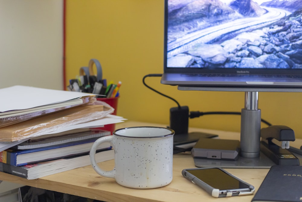 white ceramic mug on brown wooden table