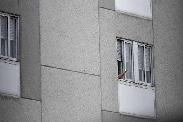 Happy Nashville homeowner giving a thumbs-up next to their HVAC unit on a sunny day.