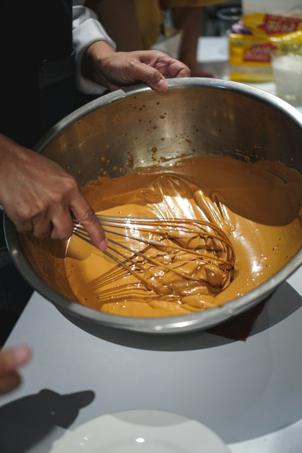 person holding stainless steel fork in stainless steel bowl