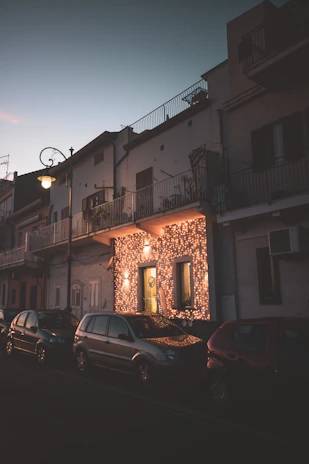A warm golden-lit street in a cozy neighborhood at dusk.