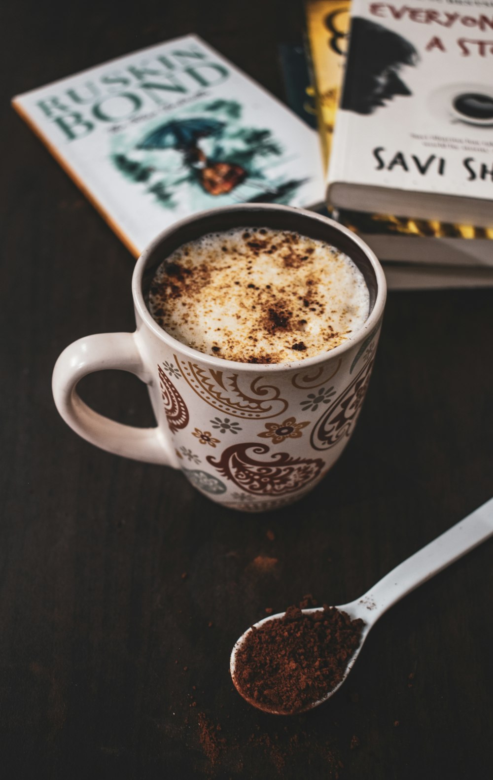 white and red ceramic mug with coffee